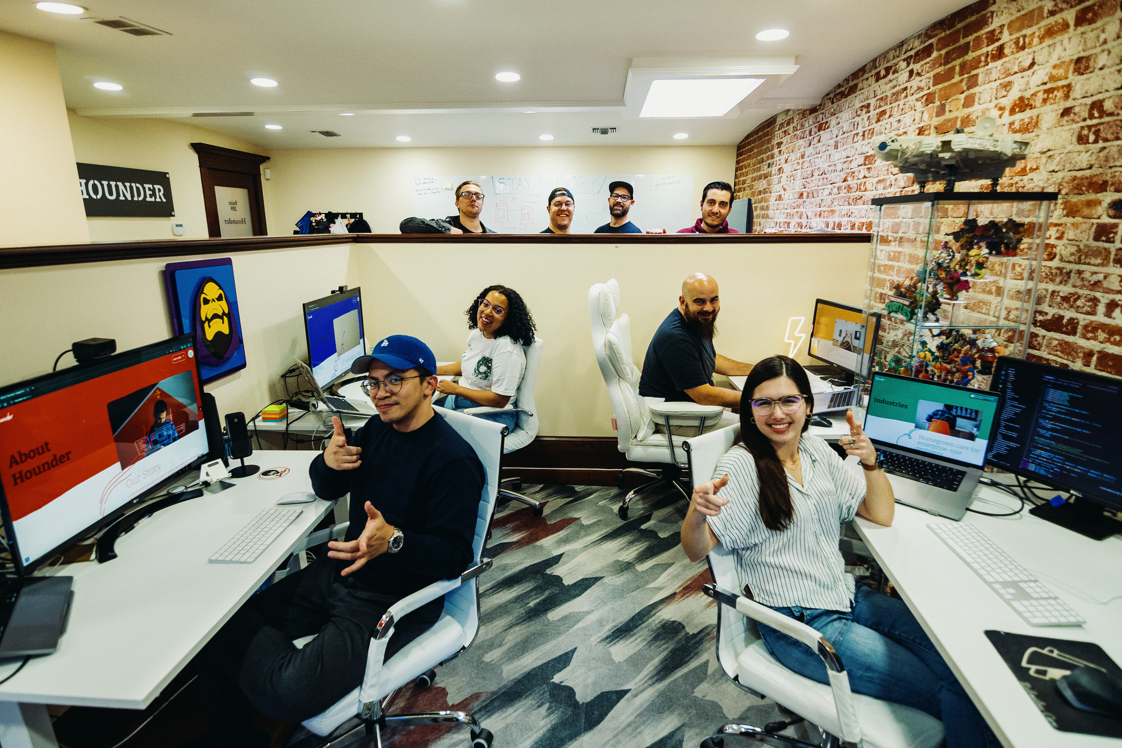 Hounder Team working on computers in a modern office space.