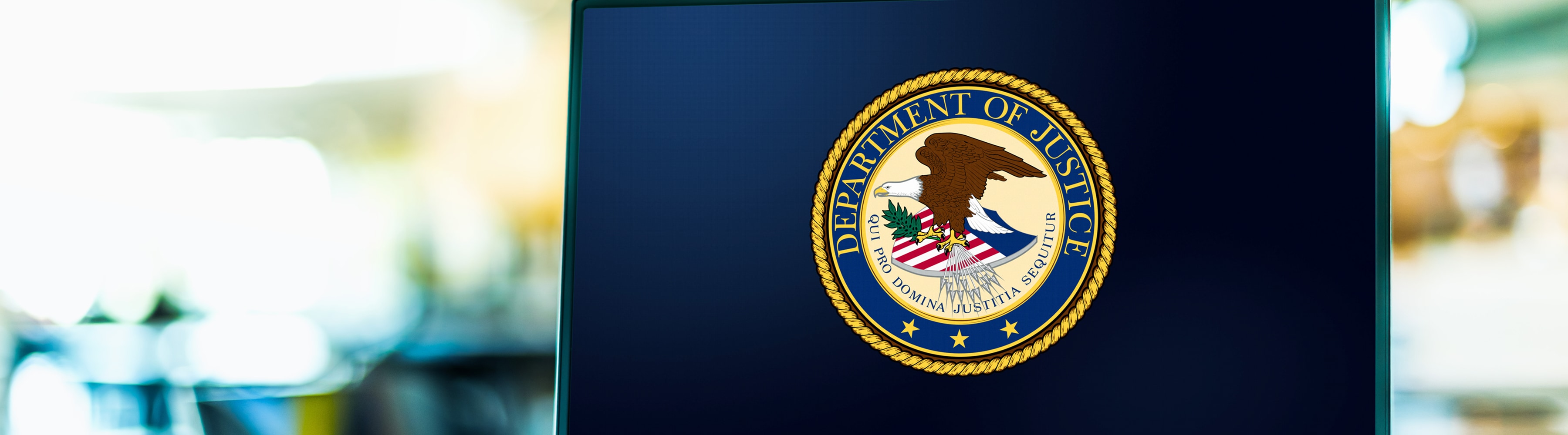 U.S. Department of Justice logo on a dark blue background.