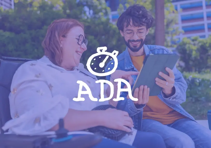 Two people smiling, looking at a tablet together outdoors.