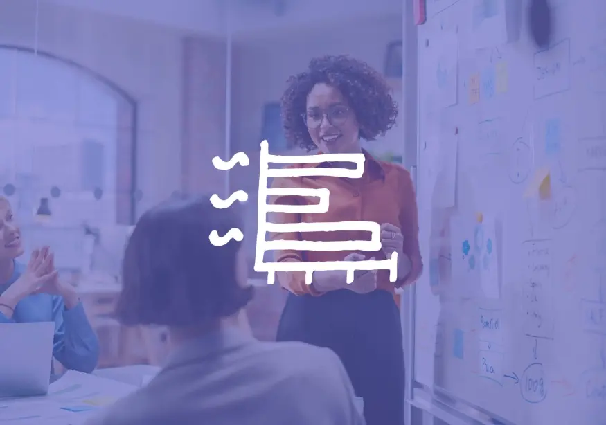 Woman presenting on whiteboard in an office, focus on speaker's expression.