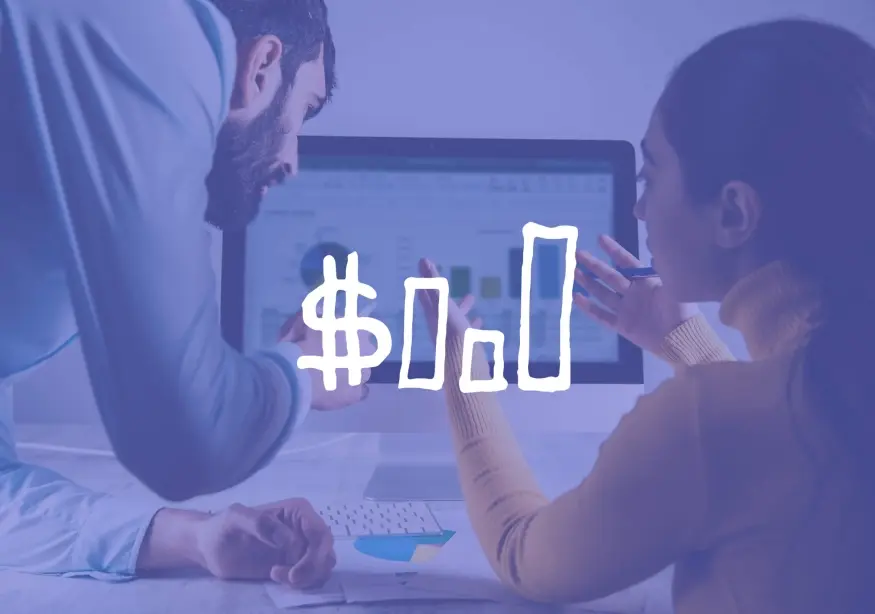 Two people discussing data on a computer screen with graphs.