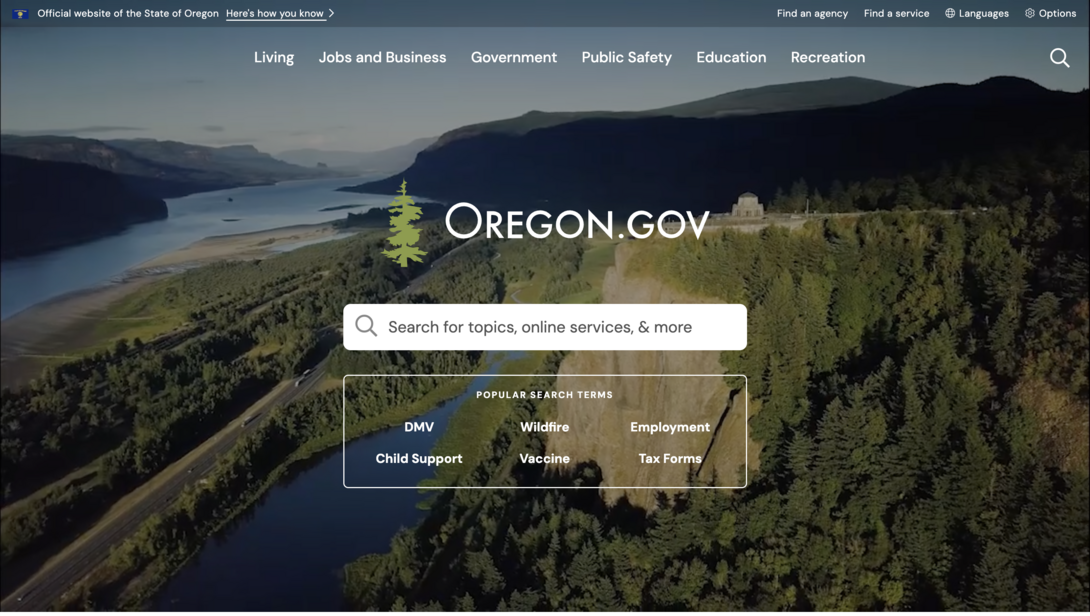 Aerial view of a river winding through lush green hills, with an Oregon.gov logo.