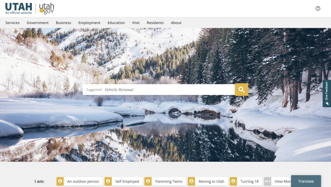 Winter landscape with snow-covered trees and a calm reflective river.