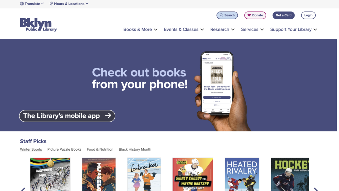 Library homepage with a hand holding a smartphone displaying a book.