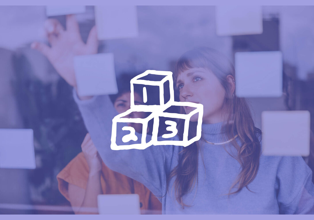 Two people arranging sticky notes on a transparent board, symbol overlay in foreground.