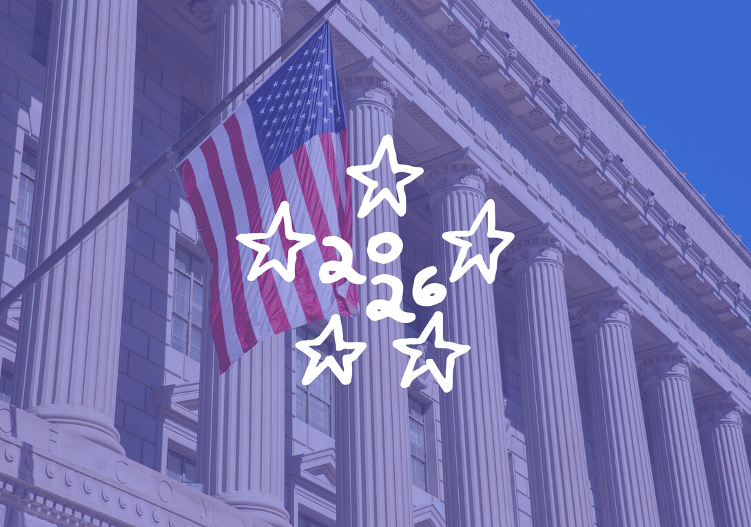 U.S. flag on building with stars and "2026" design overlay.