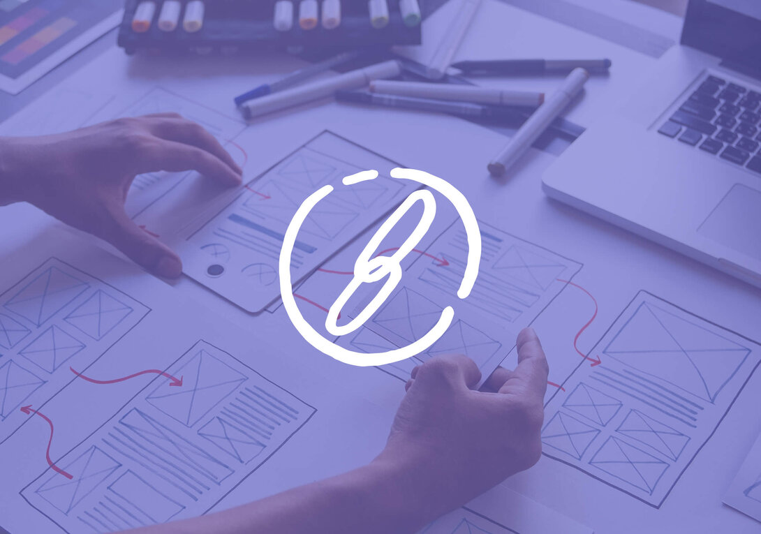 Design sketches on a table with a logo overlay.