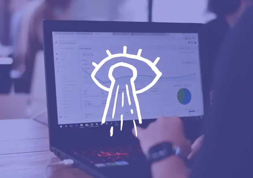 Laptop displaying analytics, hand resting on keyboard, UFO graphic overlay.