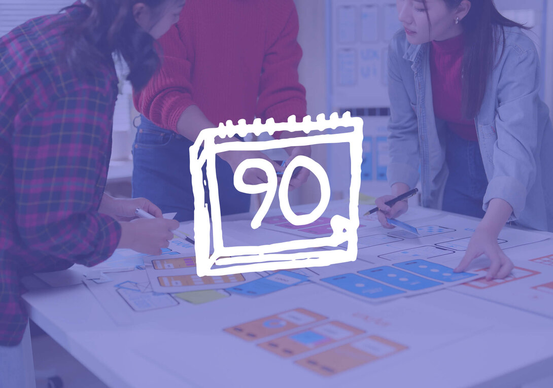 Design team collaborating at a table with a calendar icon displaying "90."