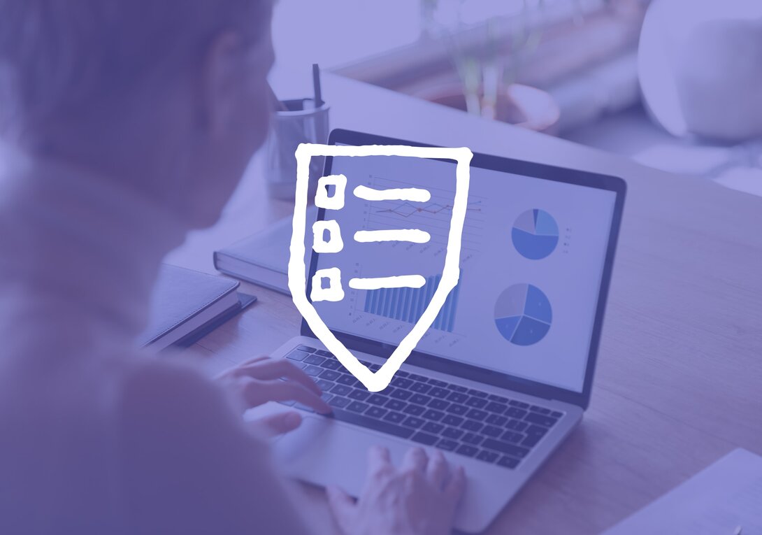 Woman working on a laptop displaying charts, shield icon overlay.
