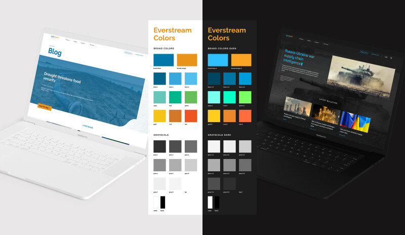Two laptops displaying web pages with color palettes between them.