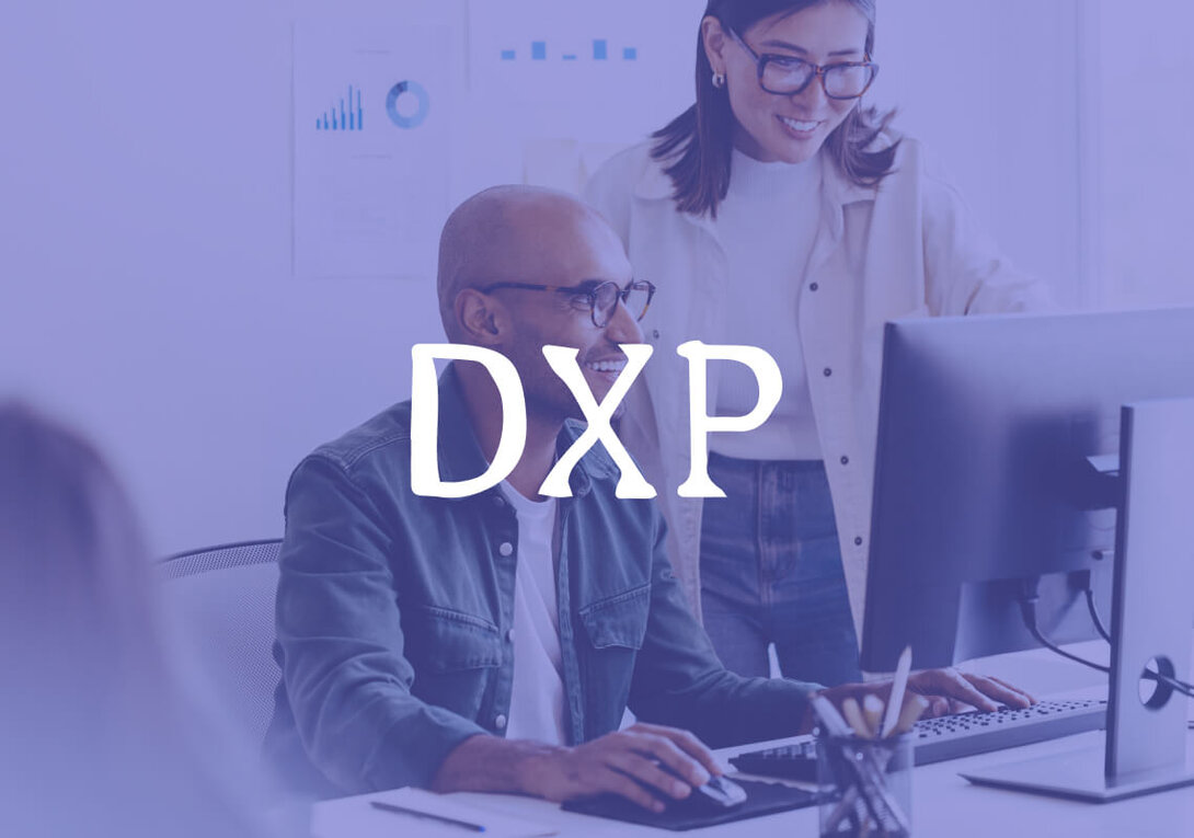 Smiling man using a computer in a casual office setting.