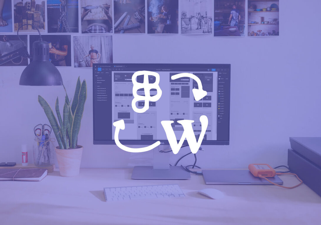 Desktop workspace with a monitor displaying a web design layout.