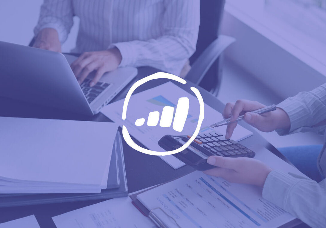 Business meeting with laptop, documents, and calculator for financial planning.