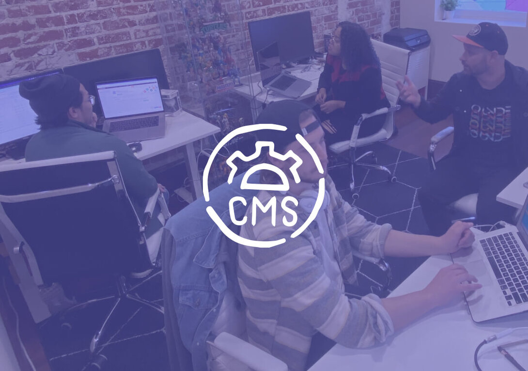 Team collaborating in an office with laptops, overlaid CMS logo.