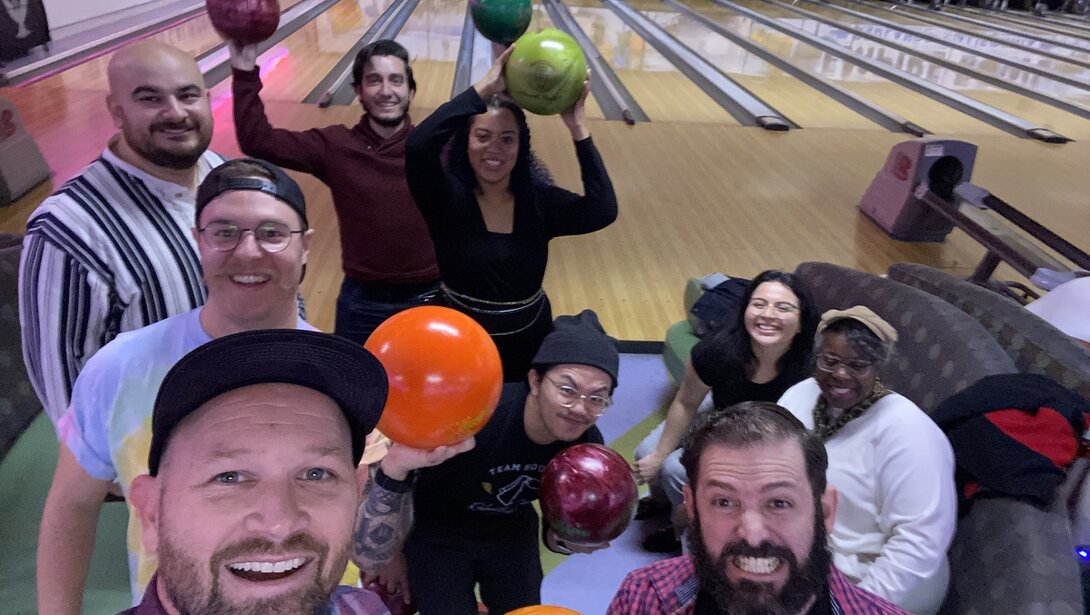Group of friends enjoying a fun bowling night with colorful bowling balls.