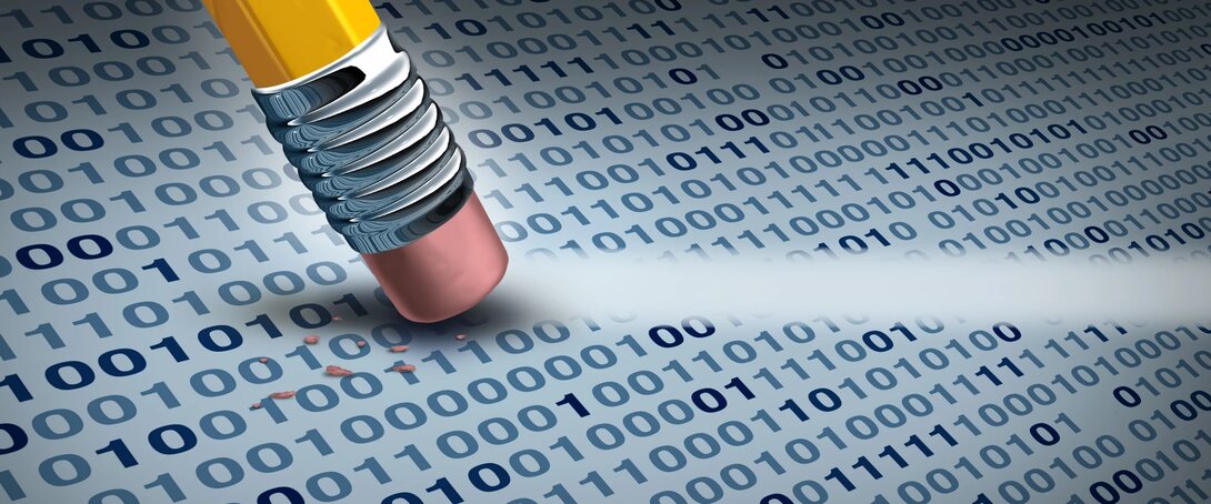 Pencil eraser removing binary code from a digital surface.