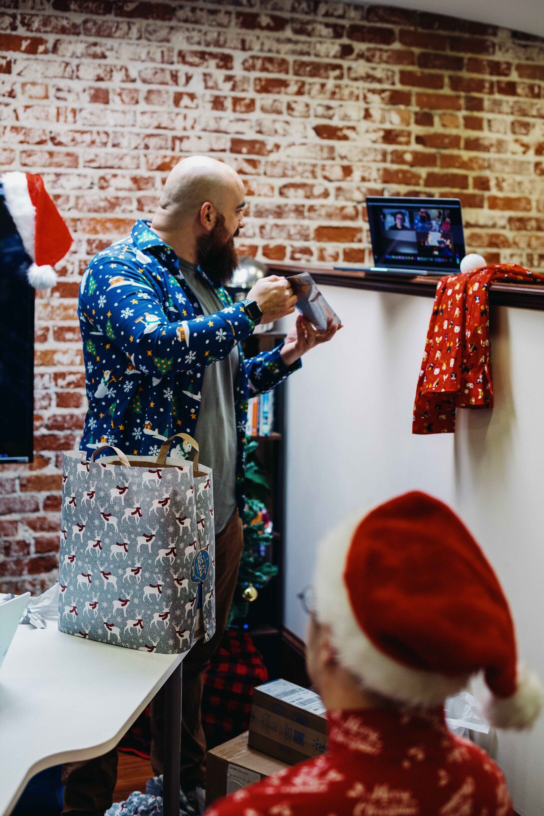 hounder team member showing remote workers secret santa gifts through zoom