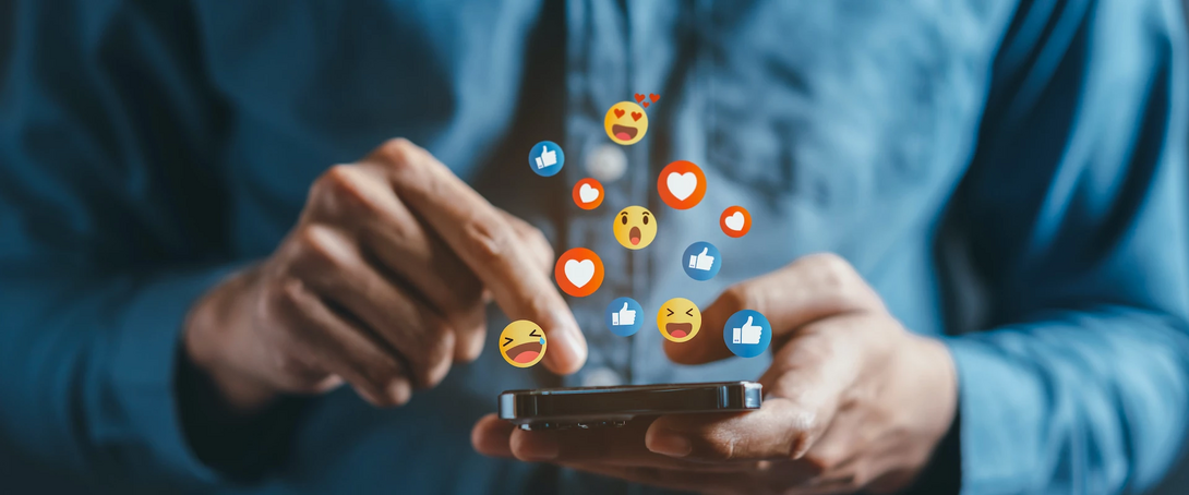 Person interacting with social media emojis on a smartphone.