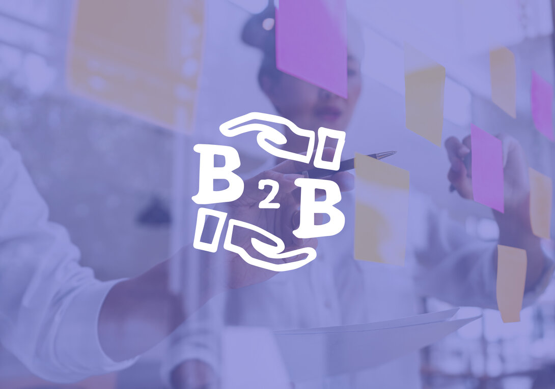 B2B collaboration concept with person arranging sticky notes on glass.